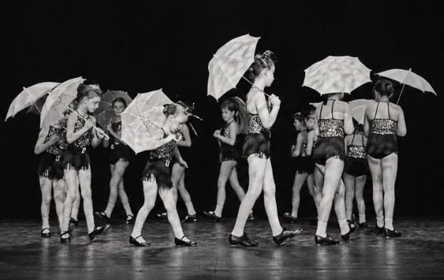 Tap dancers with parasols performing on stage